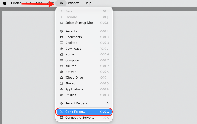 Finder menu bar open on a MacBook with the Go menu expanded and the Go to Folder option highlighted to locate hidden Chromium files.