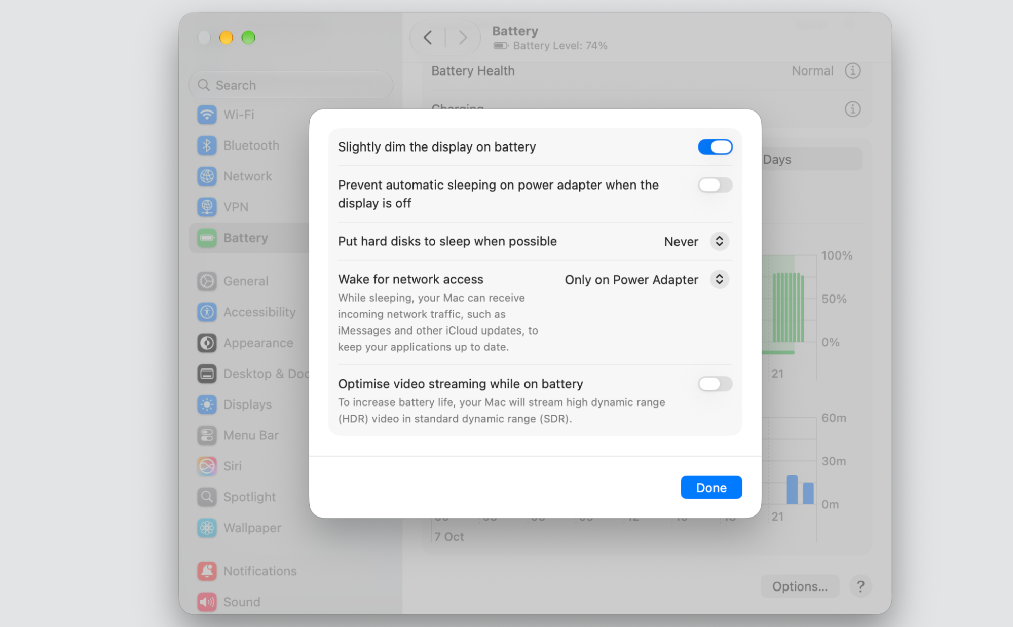 Battery Options dialog on a MacBook in macOS System Settings, with toggles to dim the display, sleep disks, and wake for network access.