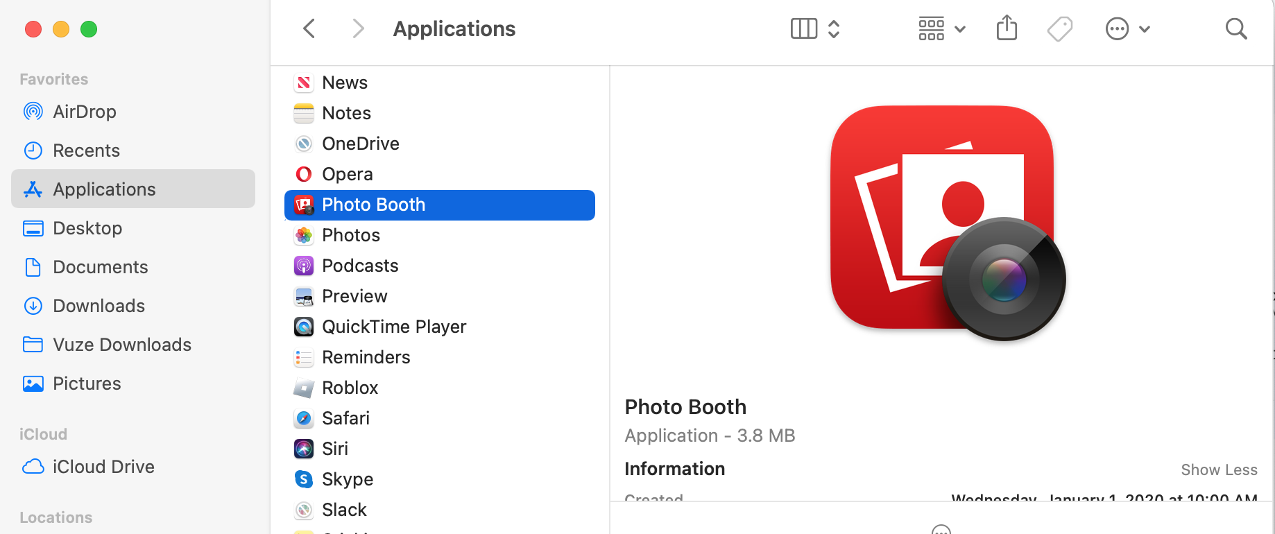 The Applications folder is open on a Mac screen. Look for the Photo Booth app and launch it to open the camera on a MacBook computer.