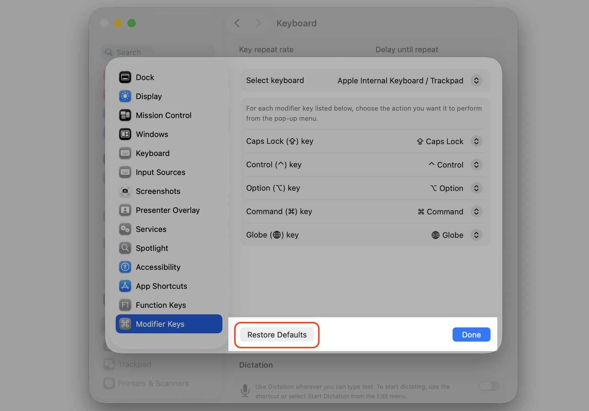 Modifier Keys window in macOS System Settings on an Apple computer, showing the Restore Defaults button to reset remapped keys for shortcuts.