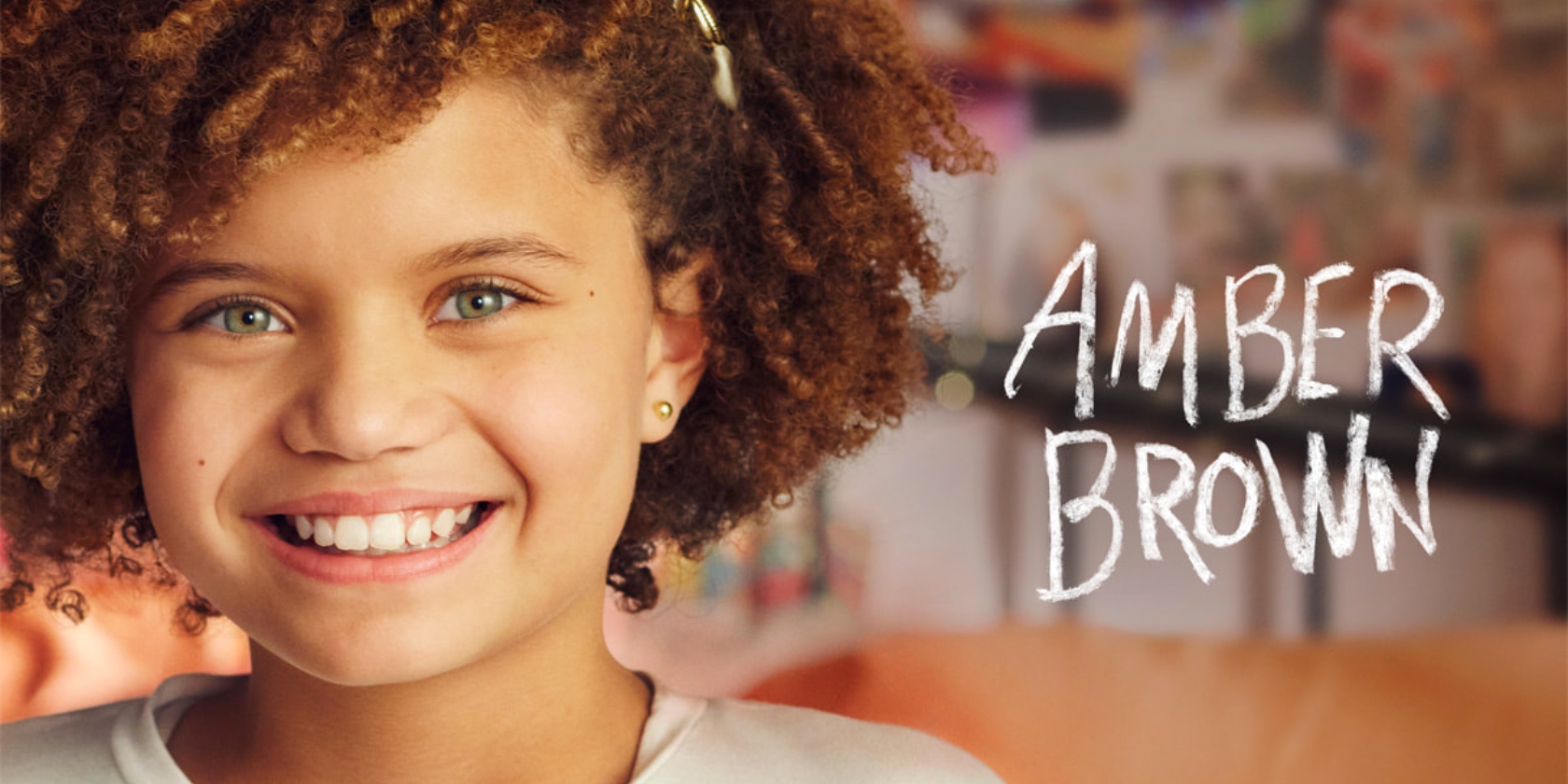 An image from the Apple TV+ series Amber Brown showing a young girl sitting down and looking out the window with a book and pens in her hand An image from the Apple TV+ series Amber Brown showing a young girl sitting down and looking out the window with a book and pens in her hand