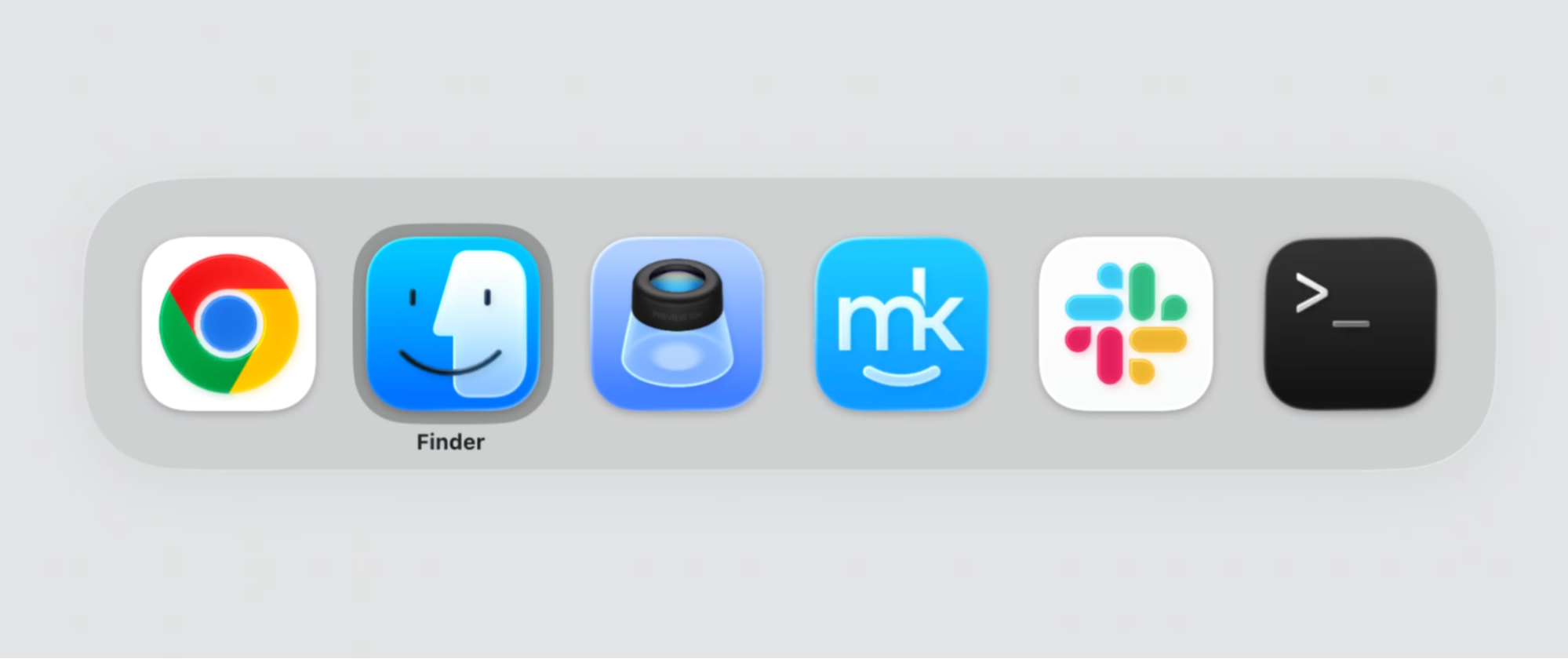 The macOS App Switcher overlay on a MacBook, a row of open-app icons with Finder highlighted as you hold Command and tap Tab to move along it.