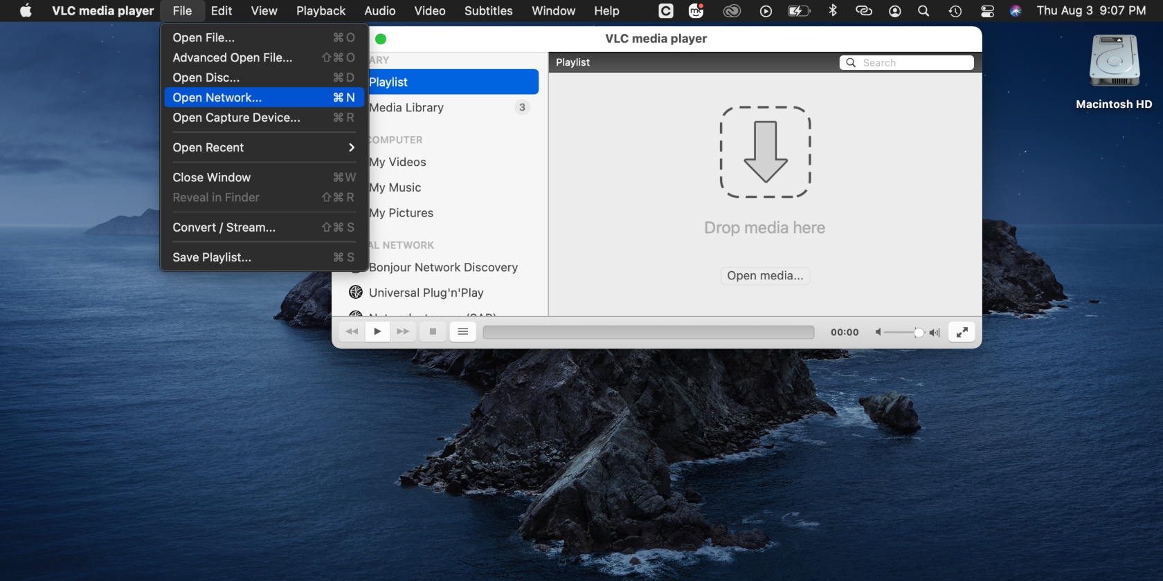 The File tab is selected and Open Network is highlighted in VLC menu options on a Mac against a dark background.