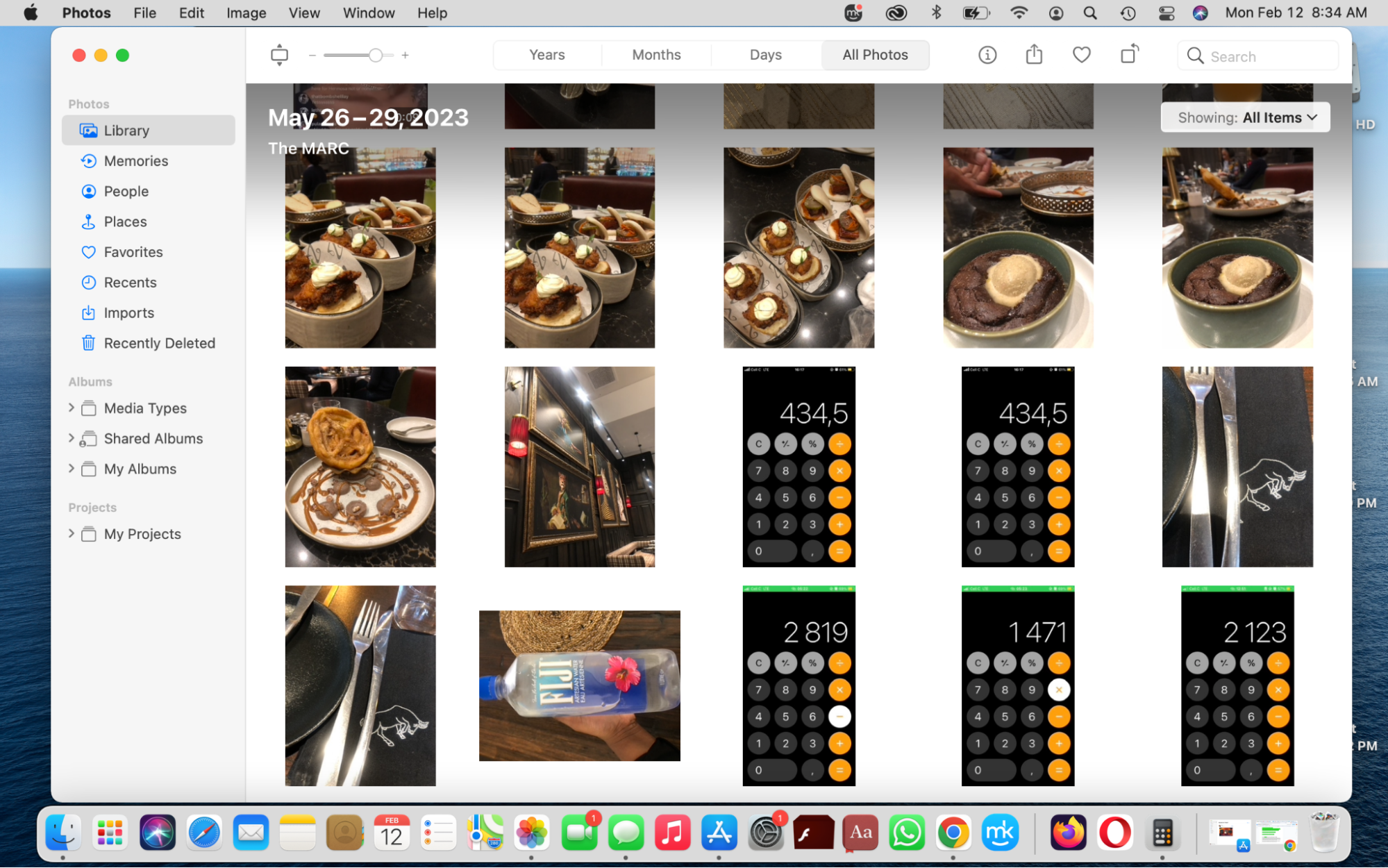 The Photos app is opened on a MacBook device. The Library category is selected and the user's images are displayed on the screen. The Photos app is opened on a MacBook device. The Library category is selected and the user's images are displayed on the screen.