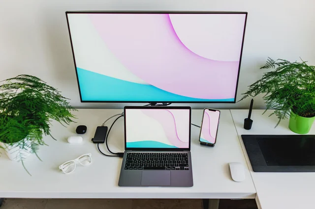 For vertically stacked displays, move your cursor to the bottom-right corner of the top screen and hold until the Dock moves to the bottom screen.