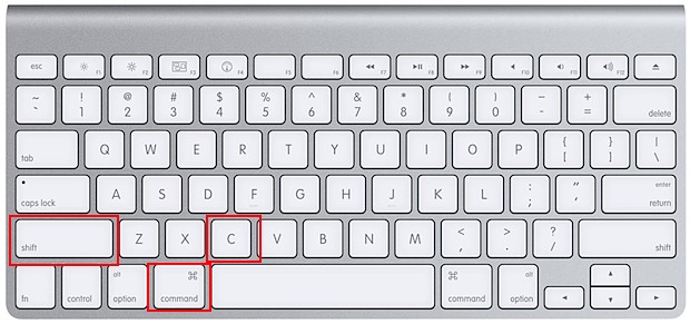 Apple keyboard with Shift, Command, and V keys marked, the browser shortcut to paste as plain text in Google Docs or Gmail on a MacBook.