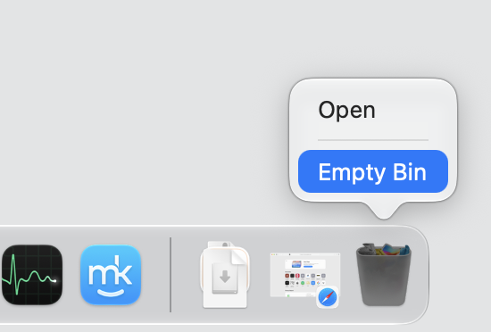The macOS Dock Bin right-clicked on an Apple computer, with Empty Bin selected to permanently delete the ChatGPT Atlas leftovers.