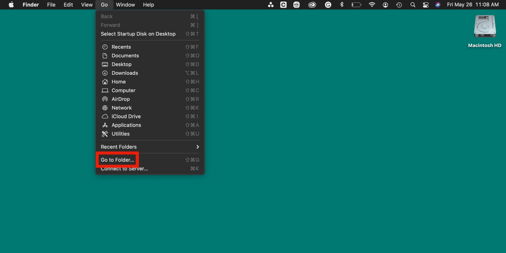 The menu bar options are depicted on a MacBook. Choose Go to Folder to delete Roblox digital remains and reinstall the app.