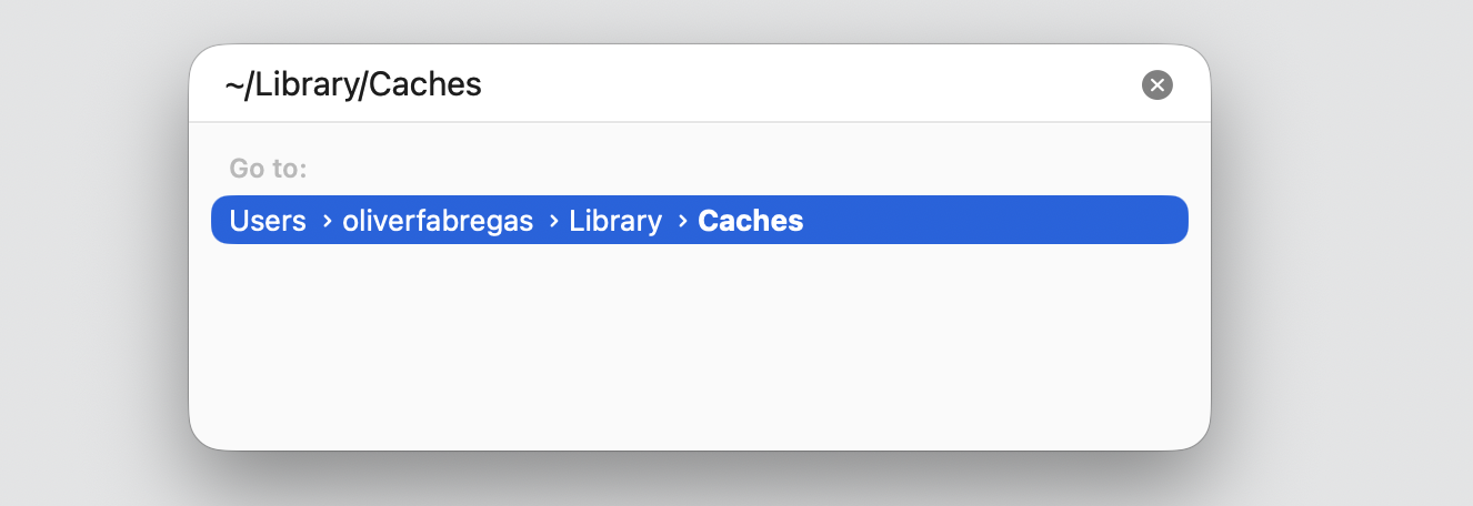 Go to Folder dialog in Finder on macOS with ~/Library/Caches typed in to locate and clear Apple Music cache and temporary files on Mac.