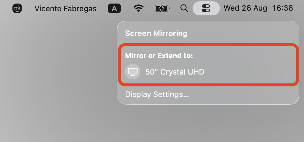 Screen Mirroring menu in macOS Control Center listing the 50-inch Crystal UHD Roku TV to select as the AirPlay target from an Apple laptop.