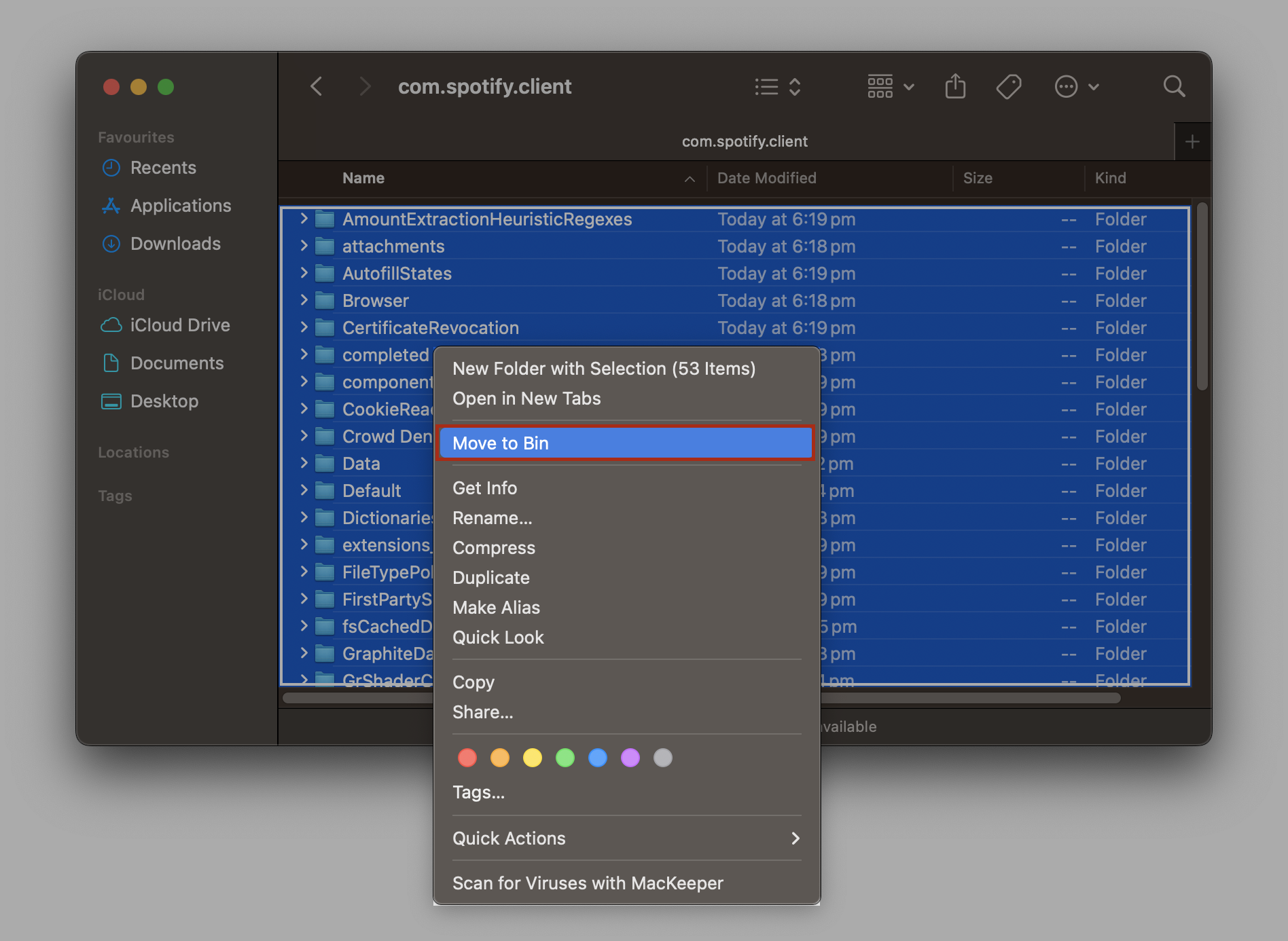 com.spotify.client cache folder in Finder on a MacBook with all contents selected and a right-click menu showing Move to Bin highlighted.