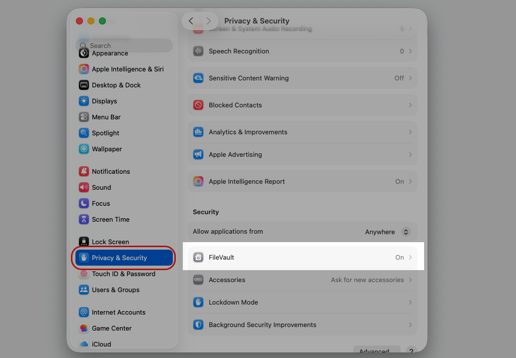 The macOS System Settings window with Privacy & Security selected and the FileVault option highlighted to find your Mac Recovery Key.