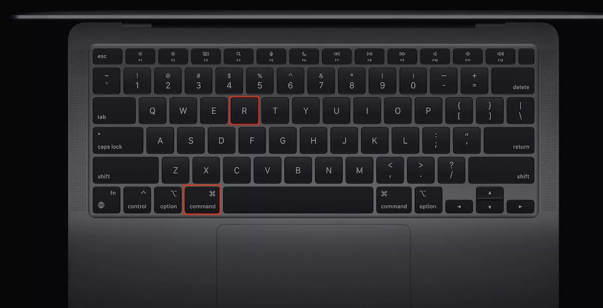A mockup of a Mac keyboard is shown. Hold down the Command + R keys until Mac’s spinning globe or the Apple logo appears.