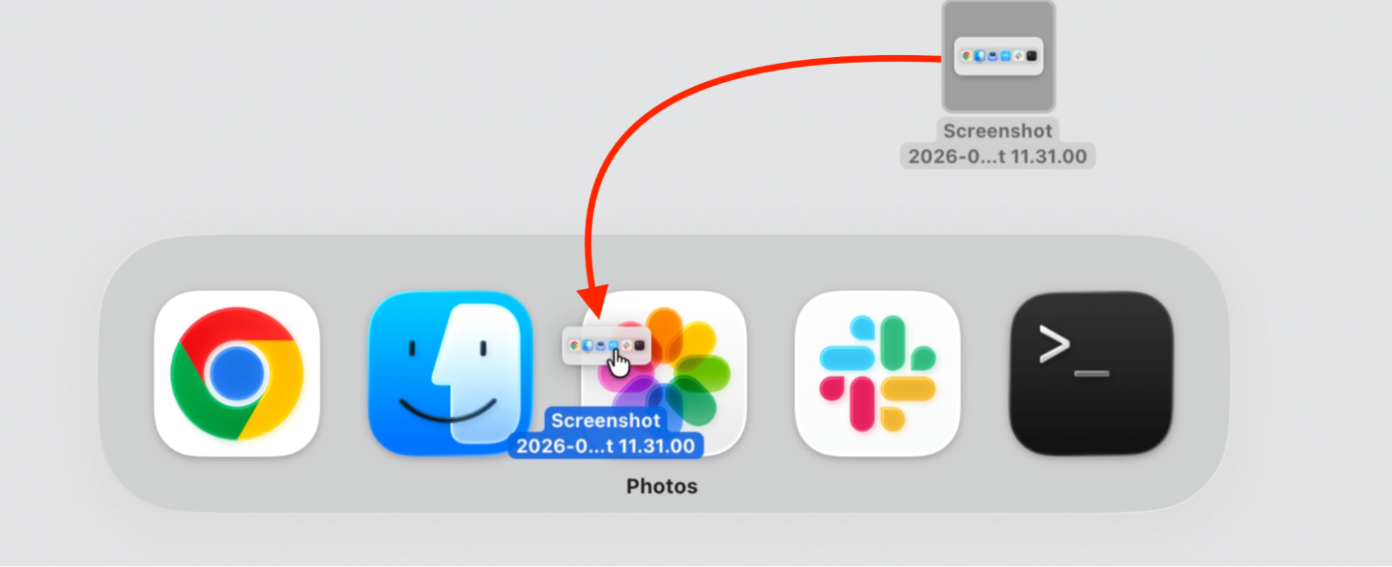 Dragging a screenshot file onto the Photos icon in the macOS App Switcher on a MacBook, dropping it there to open the file in that app.