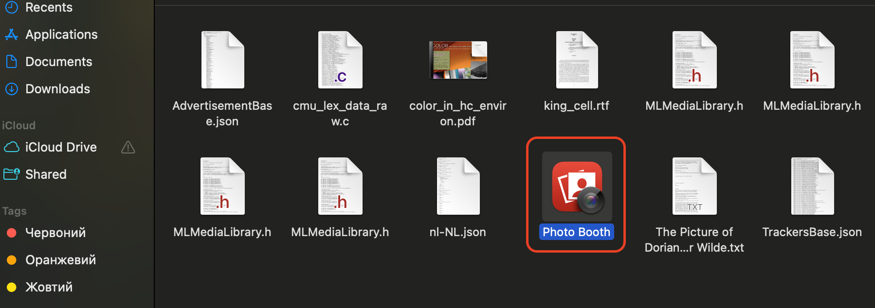 Open Finder to access the Applications folder, then locate and double-click the Photo Booth icon to launch the built-in webcam app.