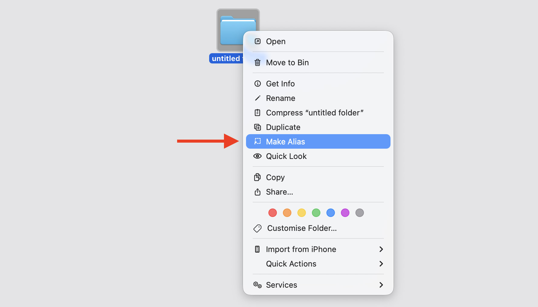 A Finder window on a MacBook where a user Control-clicks a file and selects Make Alias from the right-click context menu to create an alias.