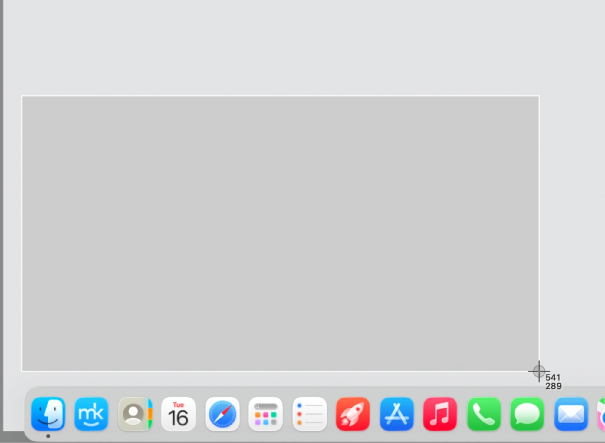 macOS selected-area screenshot crosshair dragging a box over the desktop on an Apple computer using the Shift + Command + 4 keys.