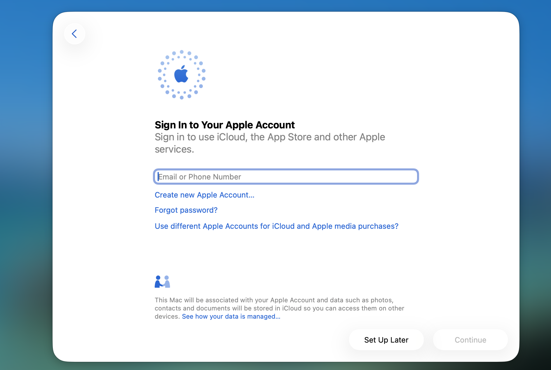 macOS Sign In to Apple Account screen on a MacBook where the new test user enters an Apple ID to enable iCloud and Apple services.