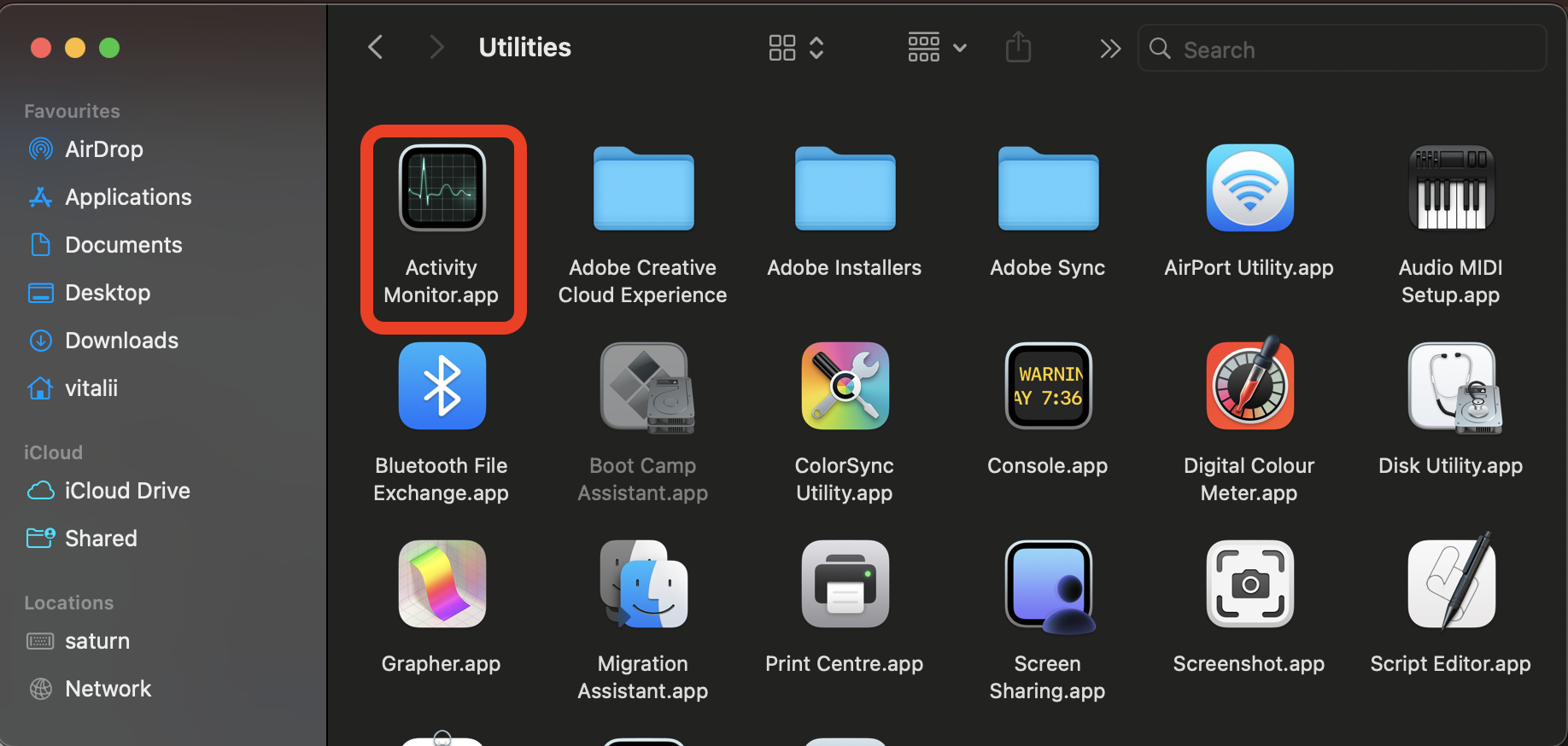 Utilities window in Finder on macOS with the Activity Monitor.app icon highlighted to open the app and force-quit Crashpad on a MacBook.