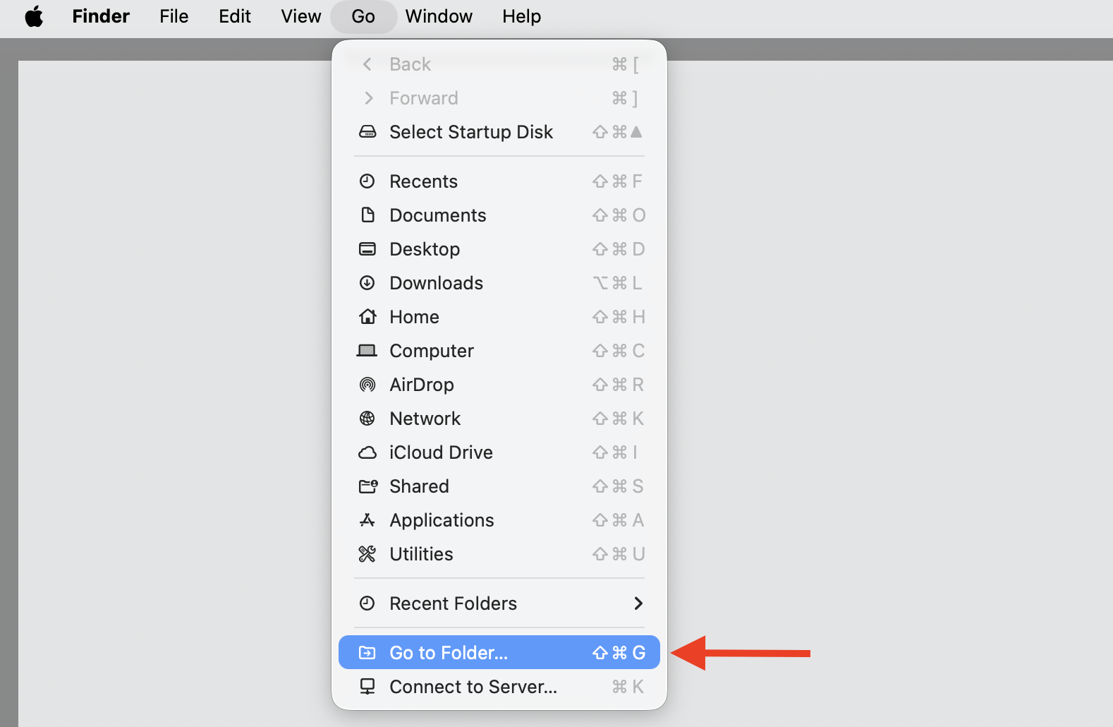 Finder Go menu open on macOS Sequoia 15 with Go to Folder selected, the first step to reset Finder settings on a MacBook.