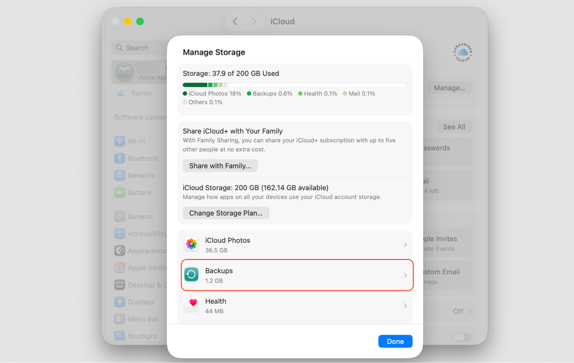 iCloud Manage Storage window on macOS listing Backups, selected on an Apple laptop to view old device backups that you can delete.
