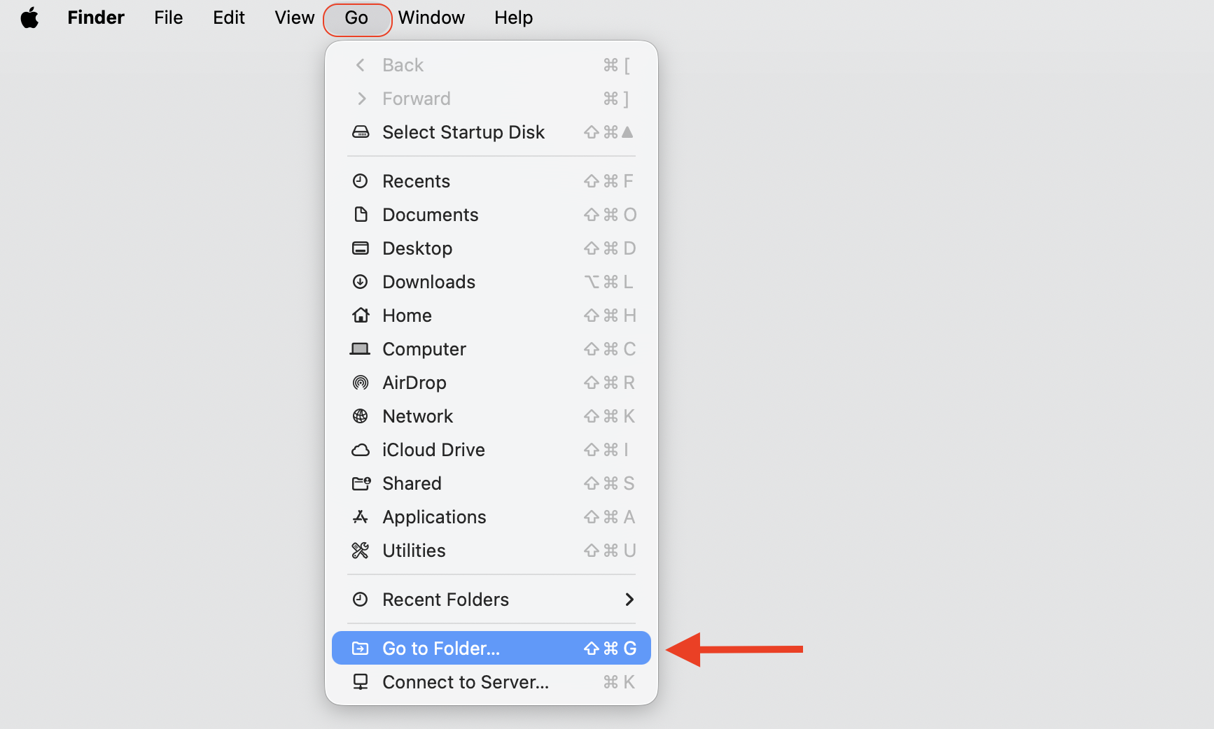 Finder Go menu open on macOS with Go to Folder highlighted, the first step to clear Apple Music cache and temporary files on a MacBook.