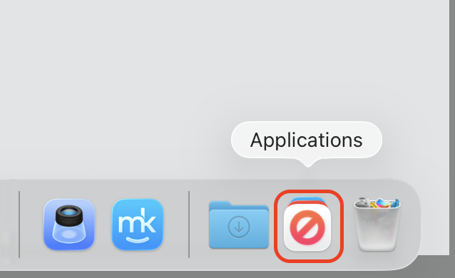 The macOS Tahoe Dock with the new Applications folder highlighted at the right end, giving a Launchpad-style grid on an Apple computer.