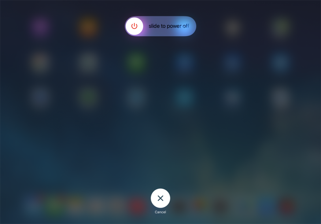 Hold the top and volume buttons on your iPad simultaneously until the power-off slider appears to initiate a device restart.