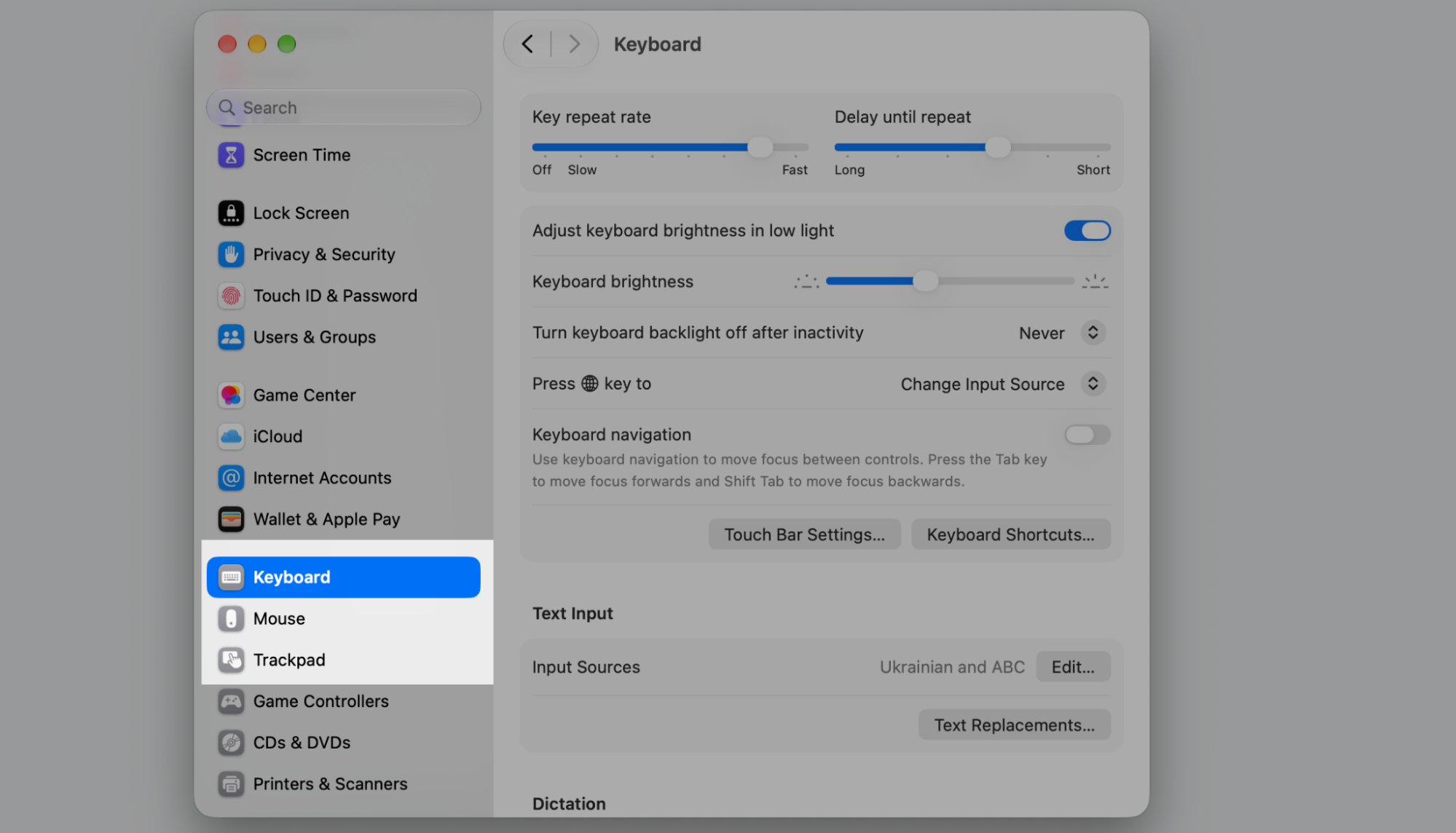 Keyboard tab selected in macOS System Settings, showing key repeat rate, brightness, and Keyboard Shortcuts options on this Apple laptop.