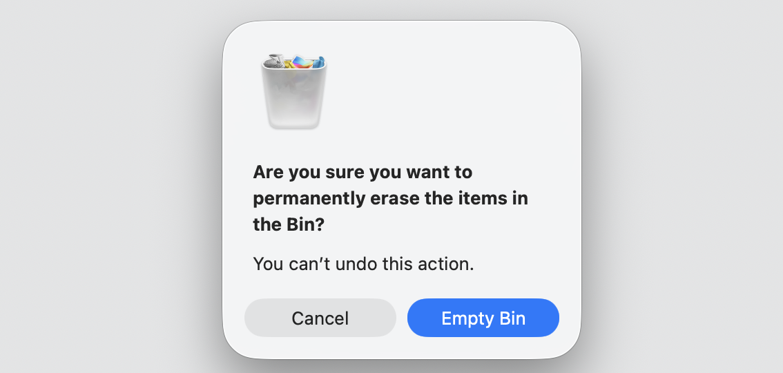 Confirmation dialog on a MacBook asking to permanently erase items in the Bin, with Empty Bin ready to reclaim disk full Apple Music space.