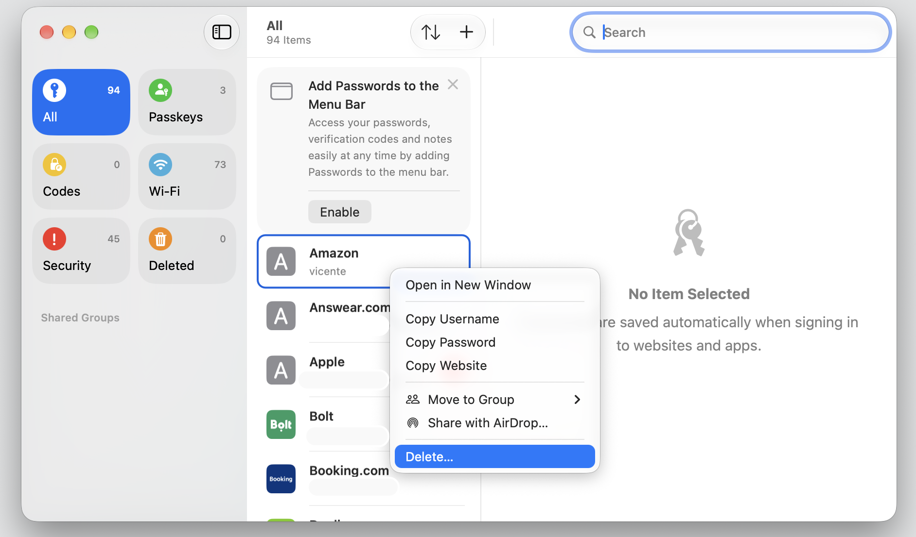 The Passwords app on a MacBook, Control-clicking a login and choosing Delete to remove the saved iCloud Keychain entry from your Apple device.