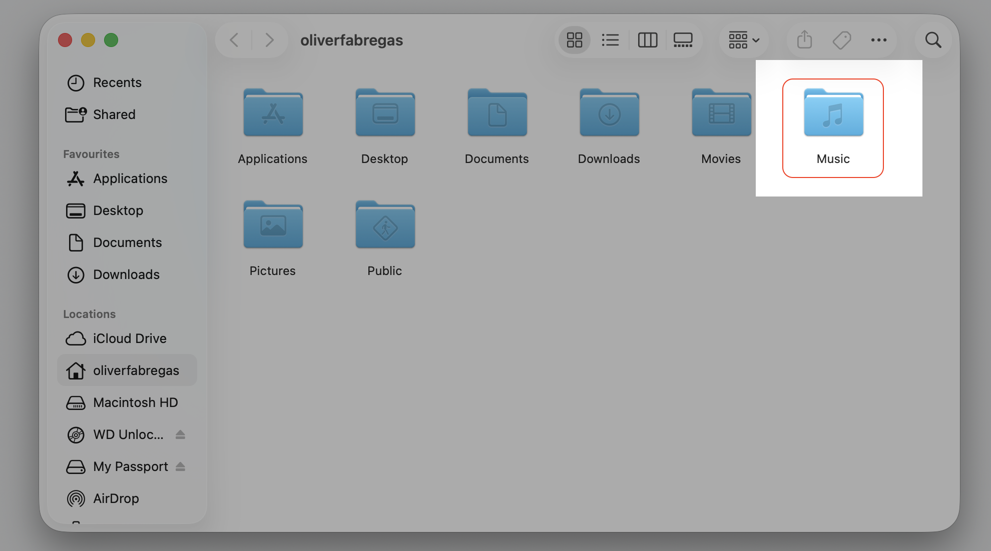 Finder home folder on an Apple computer with the Music folder highlighted, opened by holding Option to relocate the Apple Music library.