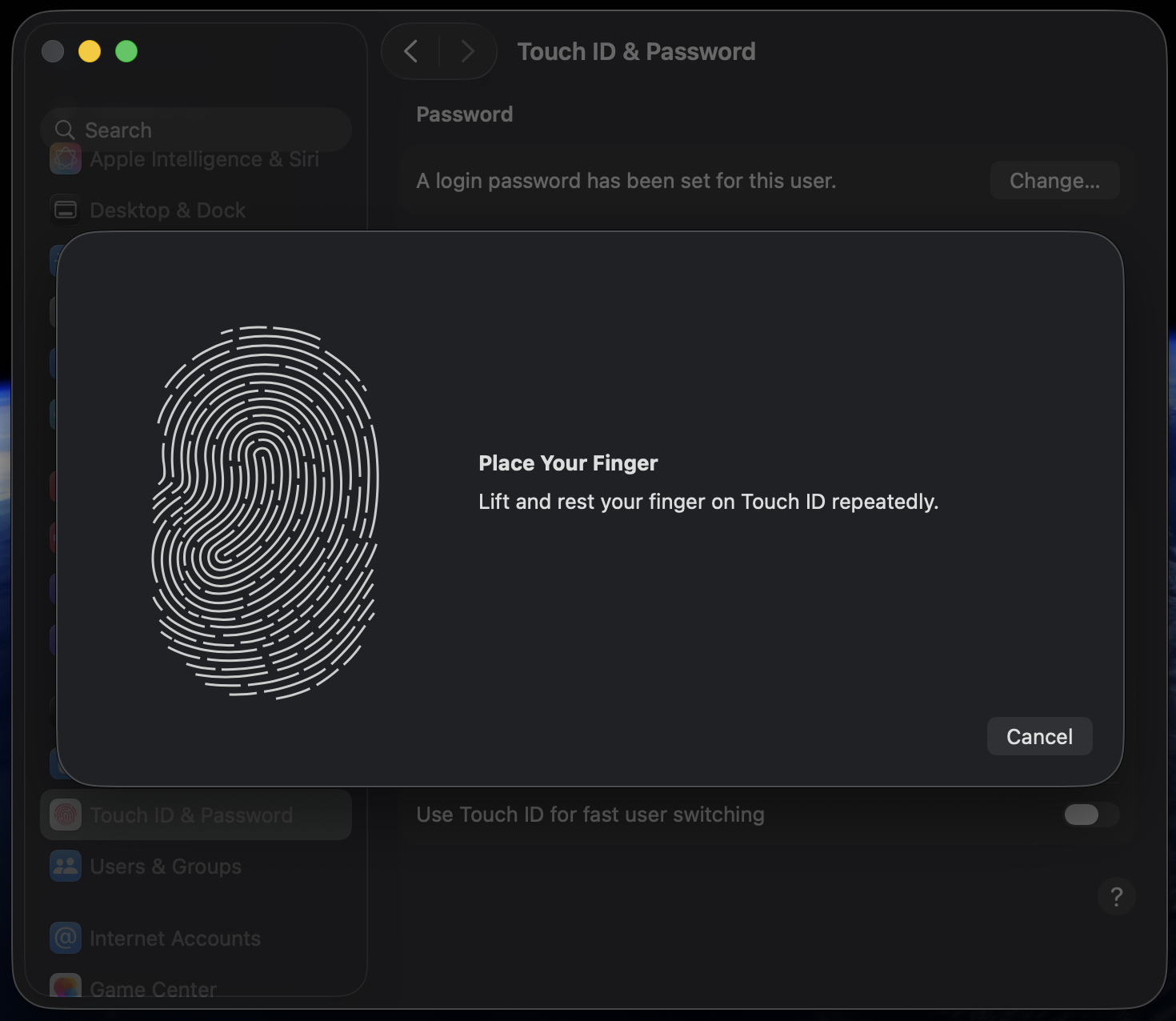 On-screen fingerprint registration prompt in macOS Sonoma System Settings on an Apple laptop, guiding the user to set up Touch ID for switching users.