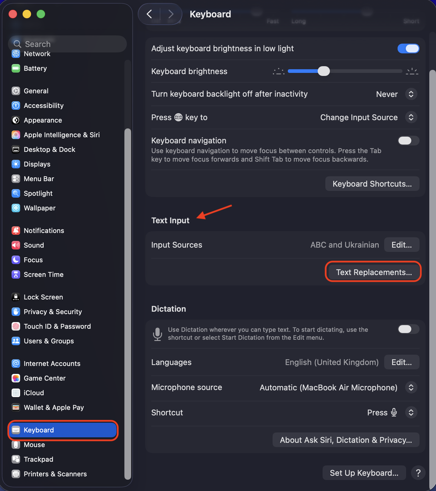 To create an em dash using text replacements, first open System Settings, then click the Keyboard option in the left menu, select Text Input, and choose Text Replacements.