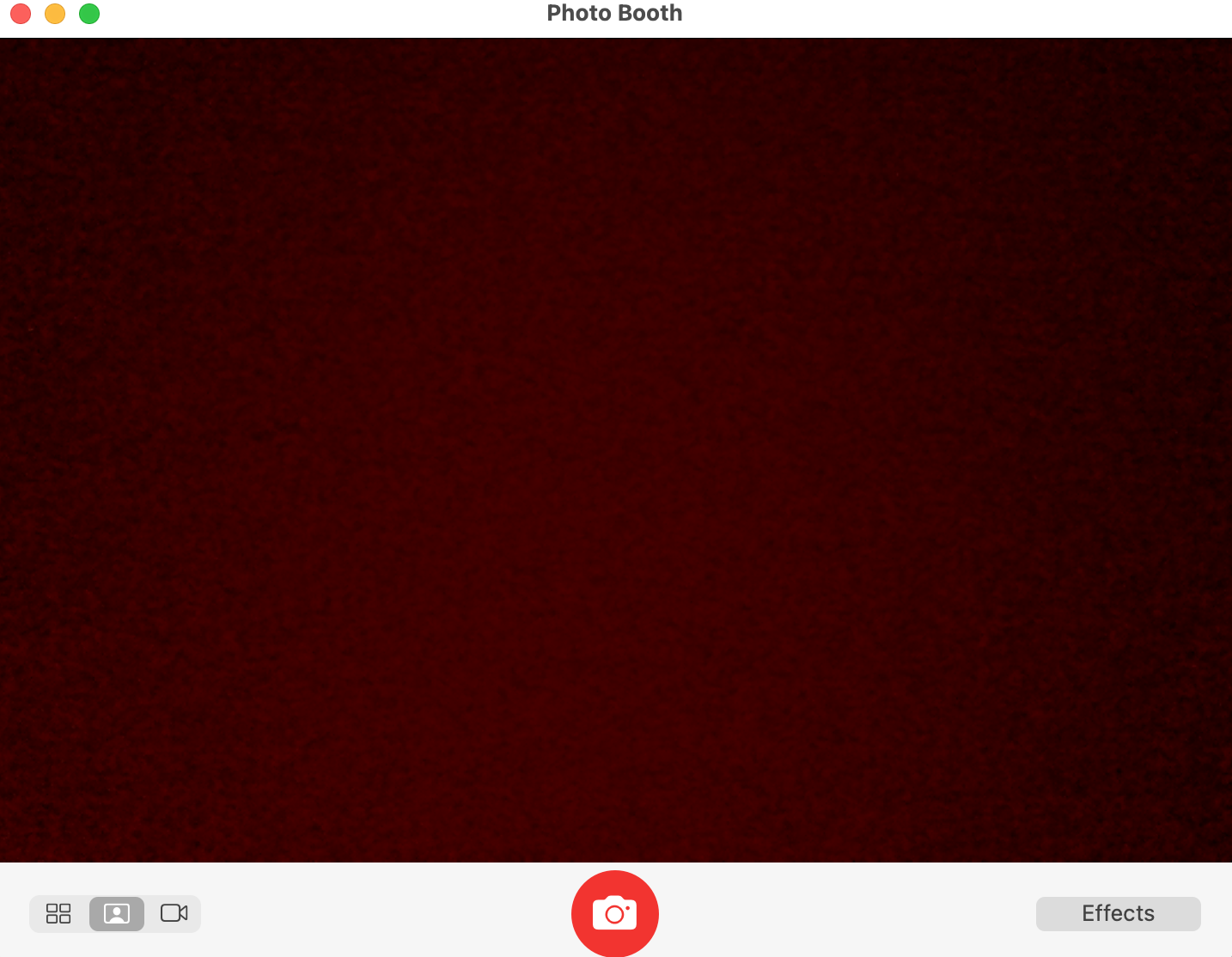 Photo Booth appears on a Mac. Make sure you’re in frame and then press the camera icon at the bottom to take a picture with a Mac camera.