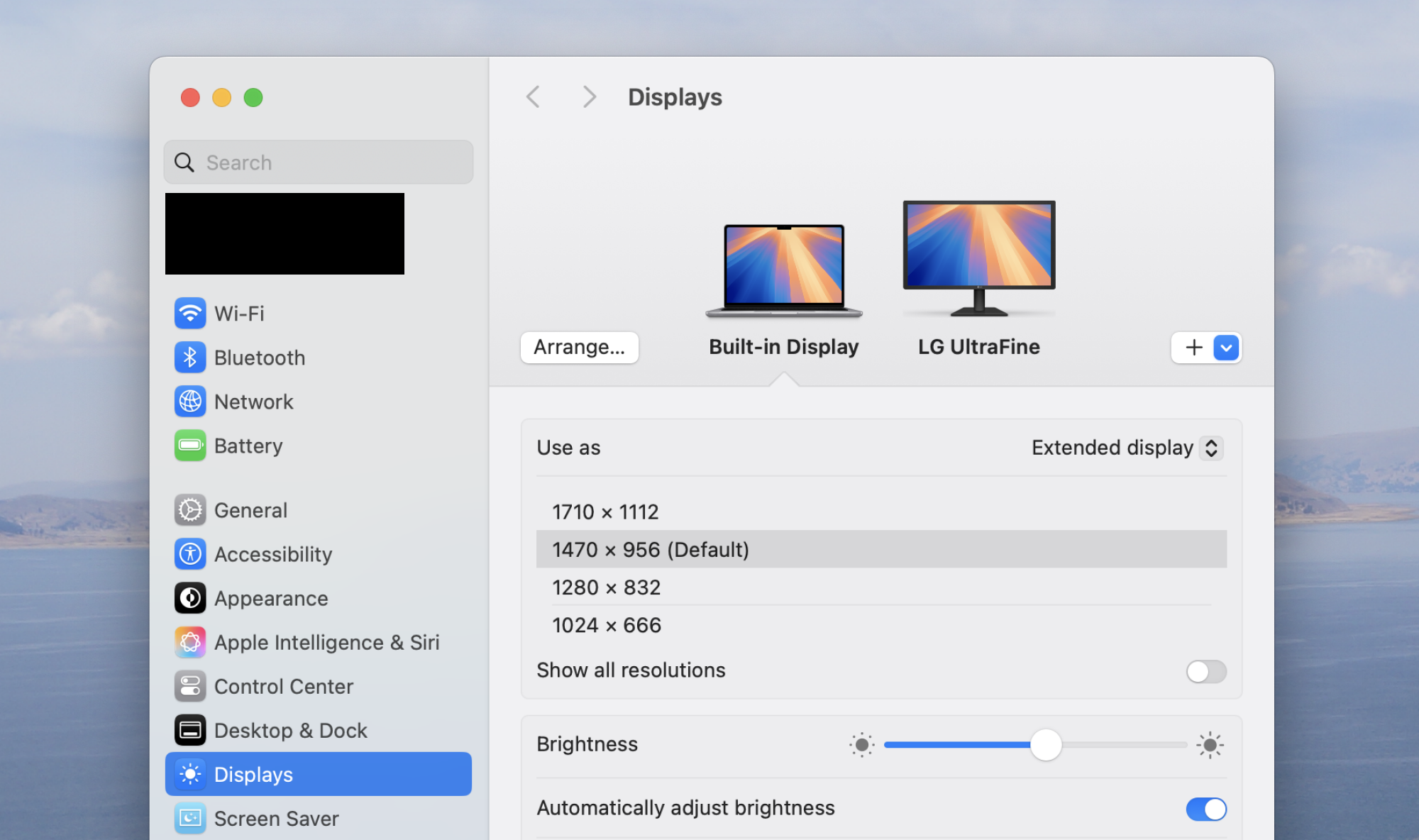 Open System Settings on your Mac, click Displays, select your preferred screen, and choose Main Display from the Use As menu to move the Dock.