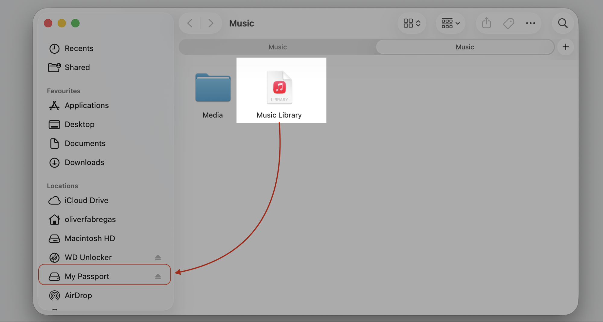 Finder window on macOS showing the Music Library file dragged to the My Passport external drive to move Apple Music off the MacBook disk.