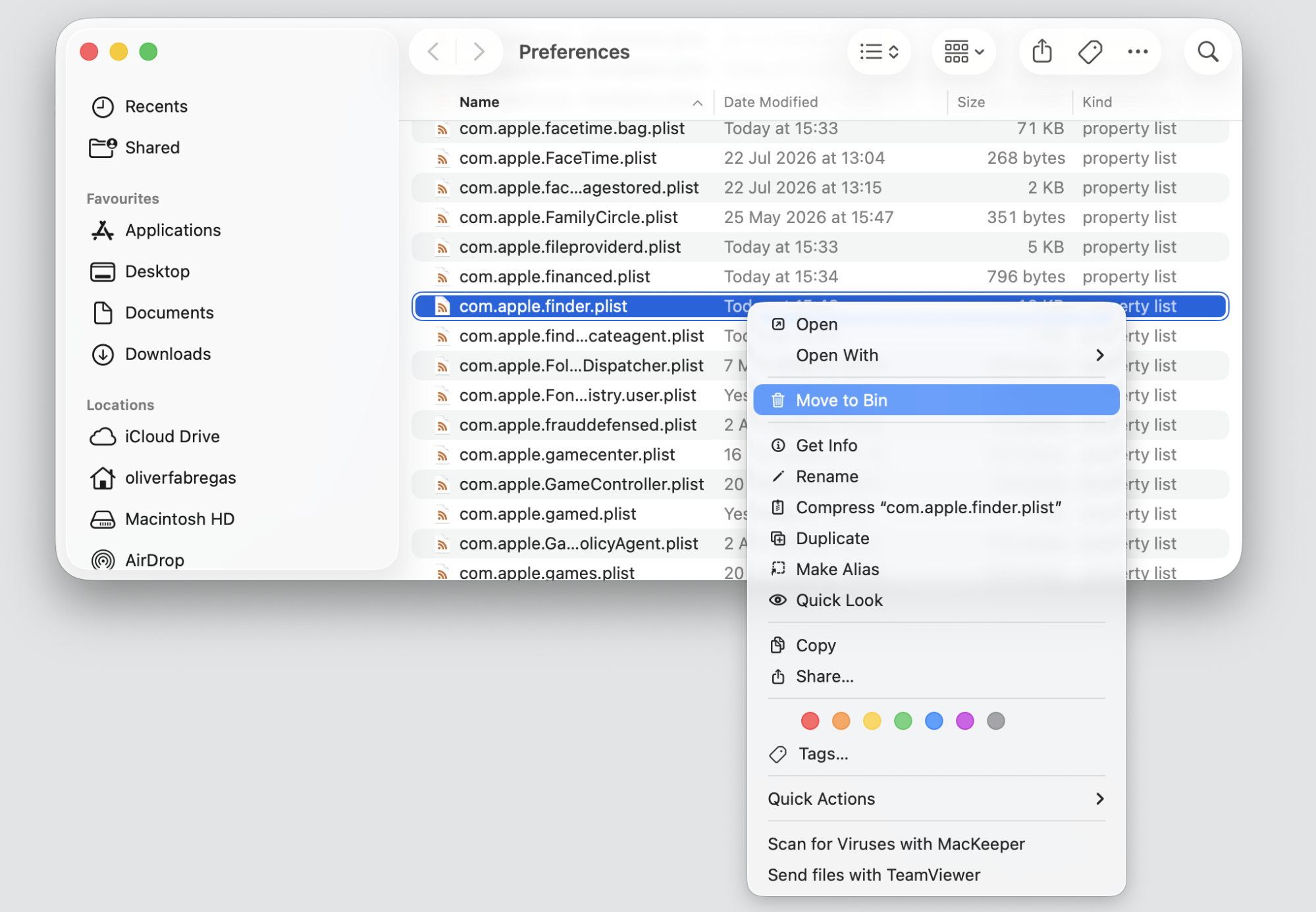 Finder Preferences folder on macOS Sequoia 15 with com.apple.finder.plist selected and being moved to the Trash on an Apple laptop.