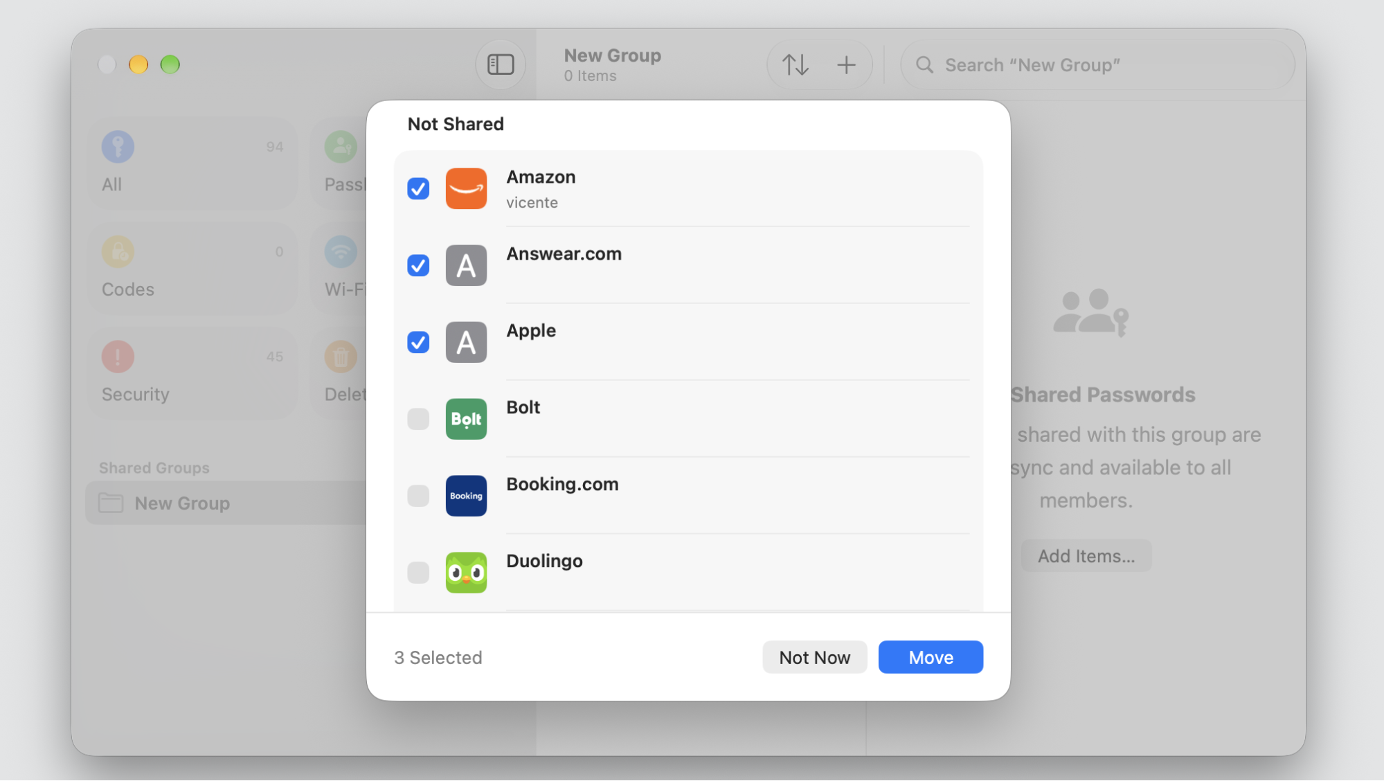 The Passwords app on a MacBook, selecting a login and pressing Move to add it to the Shared Group for secure iCloud Keychain sharing.