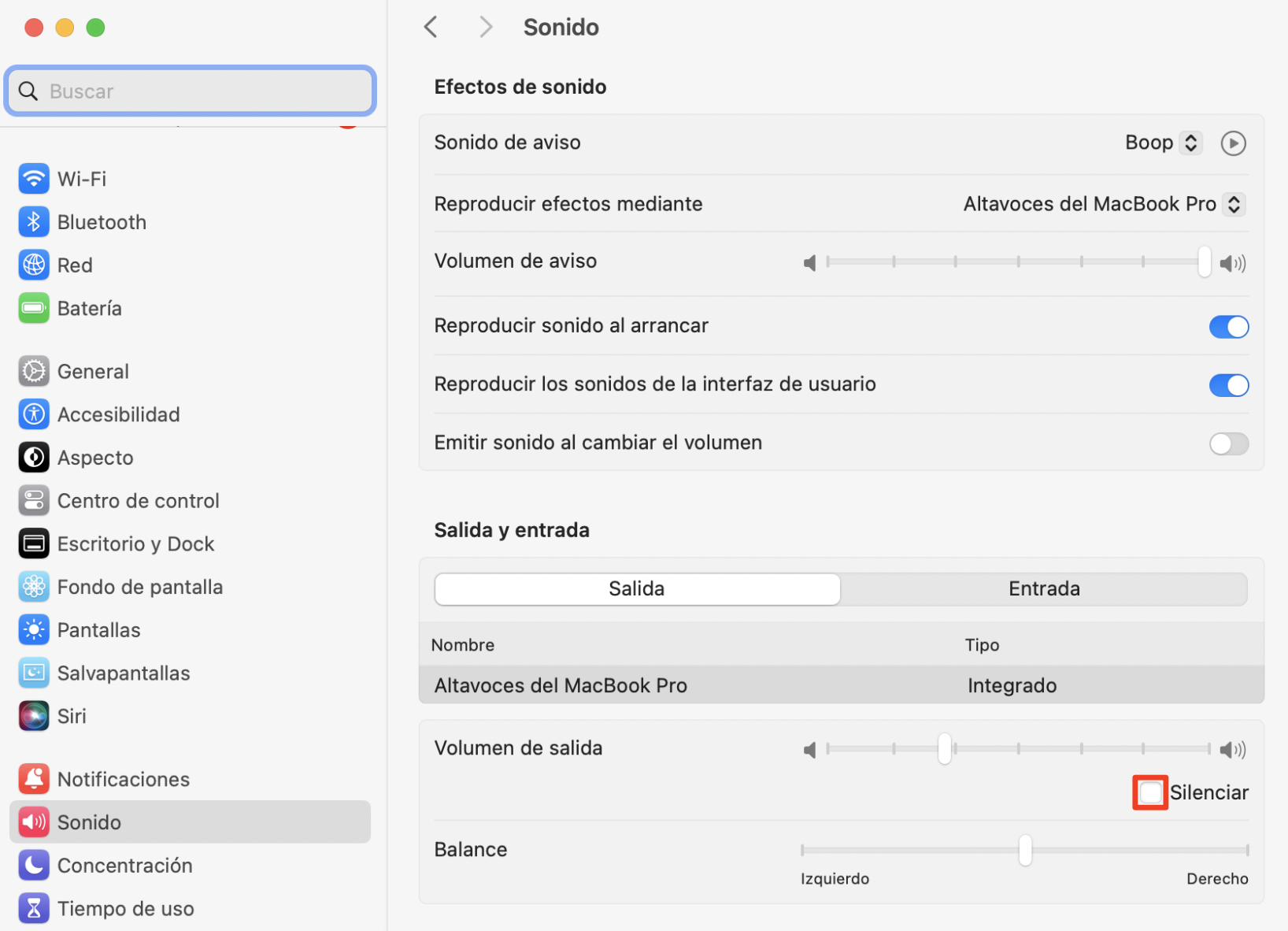 Ajustes del sistema de sonido mostrando los altavoces integrados del Mac como salida de audio y la casilla de verificación de silencio resaltada con un recuadro rojo como forma de desactivar el silencio.