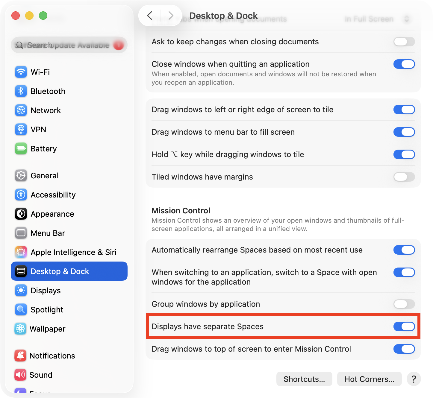 The Mission Control options in System Settings > Desktop & Dock on Mac. To set the Mac Dock to show on all screens, make sure the Displays have separate Spaces option is turned on.