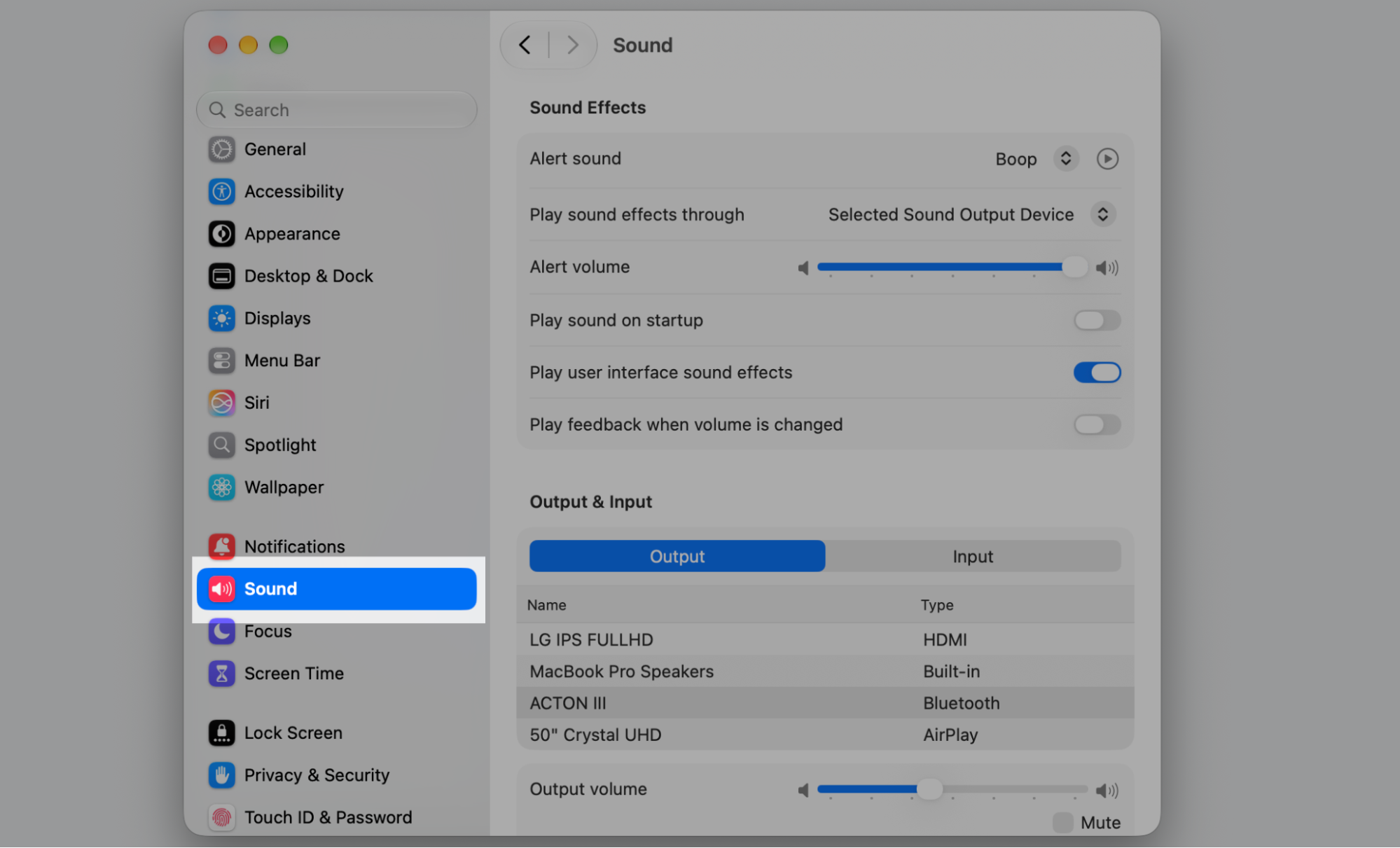 System Settings on macOS with Sound selected in the sidebar, showing Sound Effects controls and the Output device list on an Apple device.