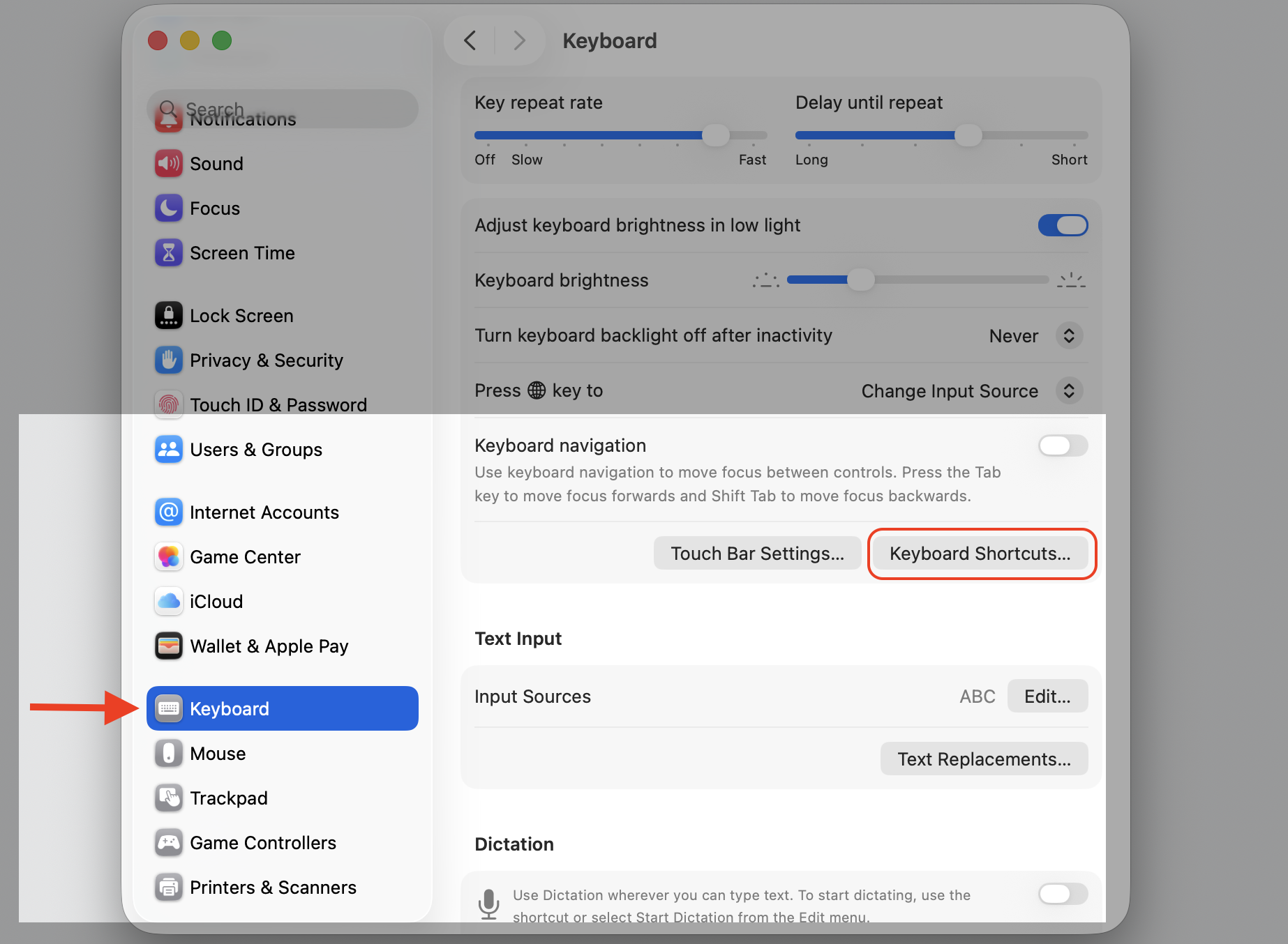 The Keyboard pane in System Settings on macOS with the Keyboard Shortcuts button highlighted to customize paste shortcuts on a MacBook.