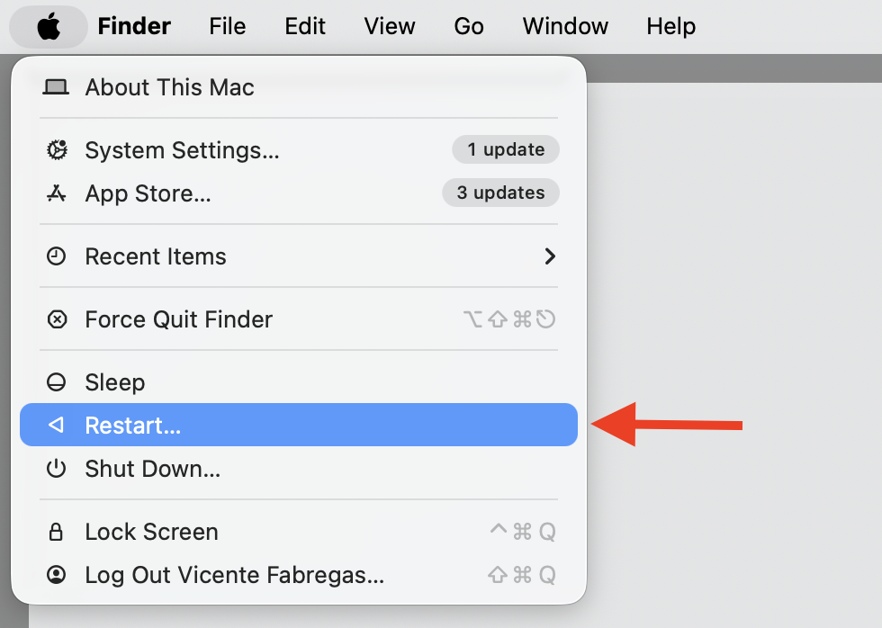 Apple menu open on a MacBook with Restart highlighted, the step to reboot and clear stuck processes after deleting ReportCrash logs.