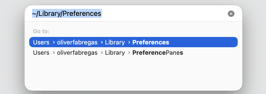 Finder Go to Folder field on macOS 15 with ~/Library/Preferences typed to open the Finder preferences folder on an Apple computer.