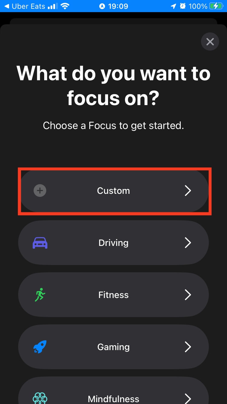 More focus mode options appear on an iPhone screen. Choose the Custom option to use schedule notifications on your iOS device.