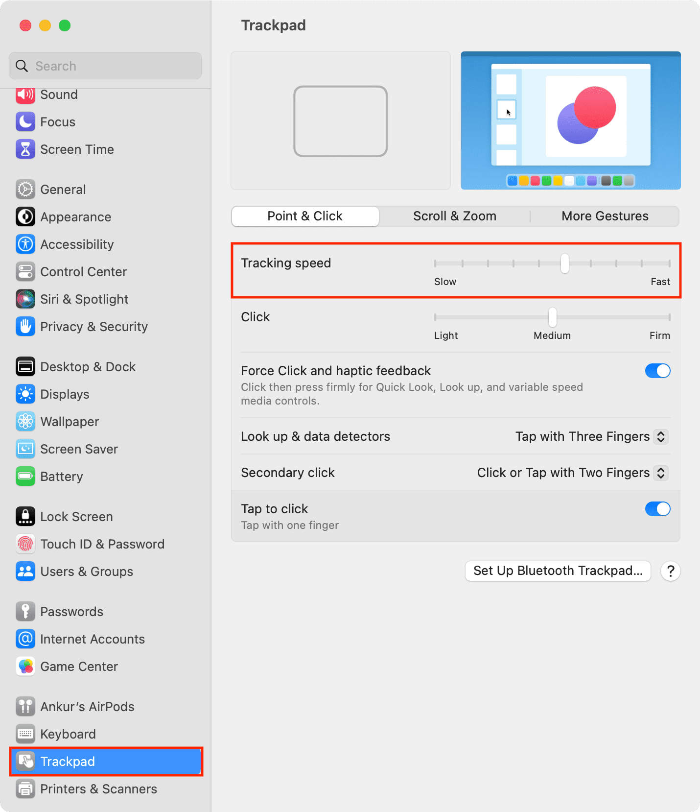 Trackpad settings appear on a MacBook screen. Drag the Tracking speed slider in any direction to change the mouse speed on your Mac.